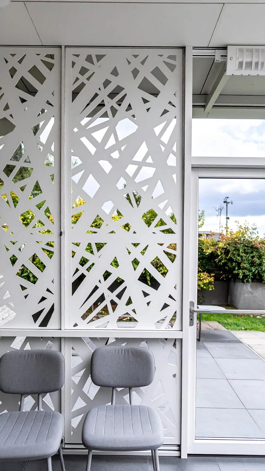 White decorative fence panels installed in an outdoor seating area