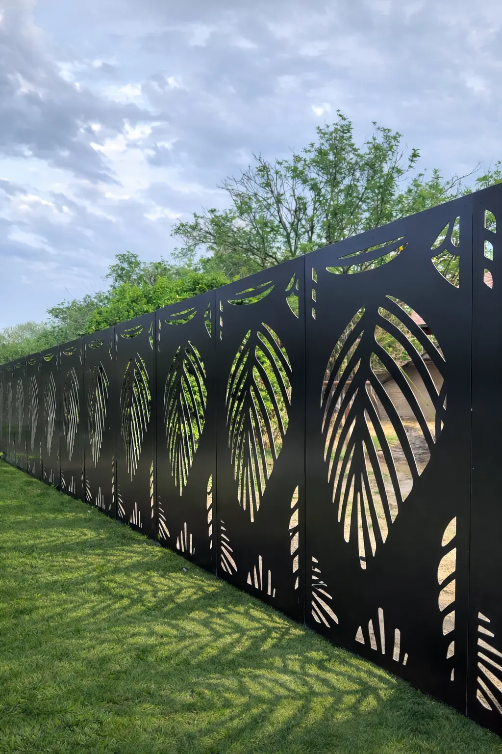 Black aluminum palm pattern fence panels installed outdoors